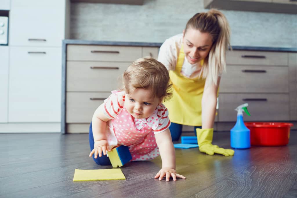 If you want to know how to get kids to do chores, you should give chores that are age appropriate. This toddler is helping her mom clean the floor.