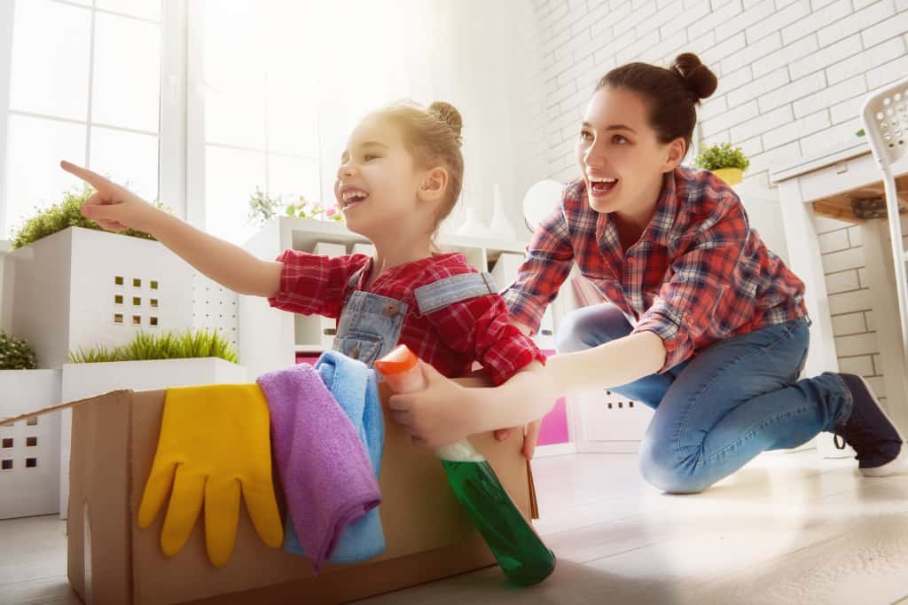 Make cleaning fun by going on secret cleaning missions. The mom and girl are pretending to go on a mission.