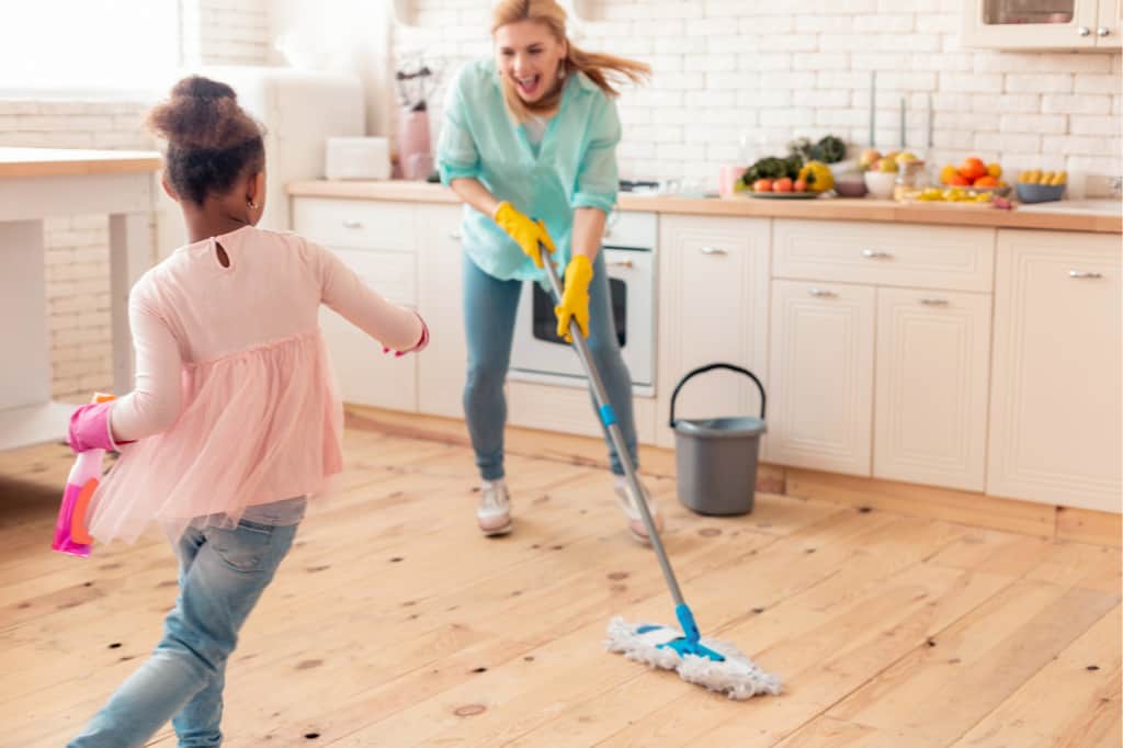 Make cleaning fun for kids by racing. This mom and girl are seeing how fast they can clean.