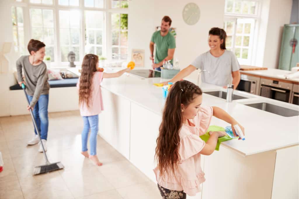 family working together to keep the kitchen clean