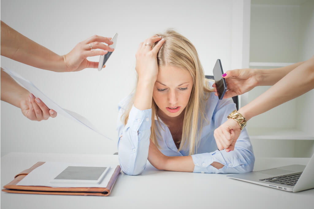 saying no is something highly productive people do. this woman is surrounded by people asking her to do things.