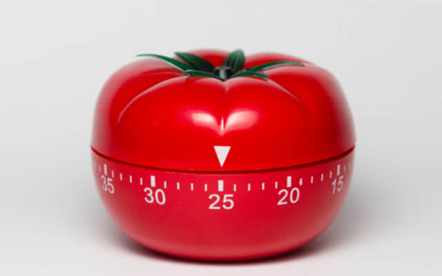Red tomato Pomodoro timer set to 25 minutes. A productivity tip is to break tasks into 25 minute increments to maintain focus